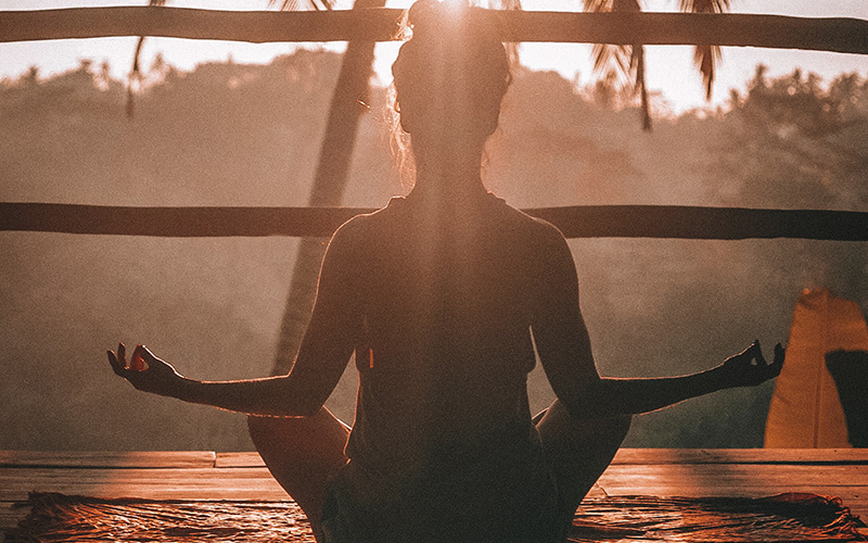woman sitting alone practicing mindfulness meditation