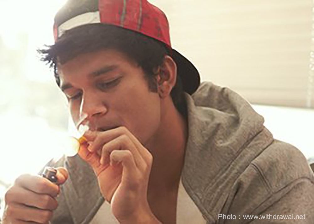Young male smoking some sort of unidentifiable drug