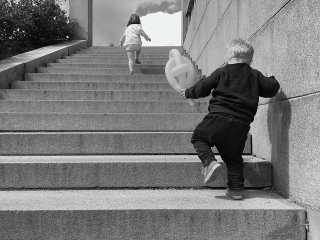 Two kids walking up the stairs