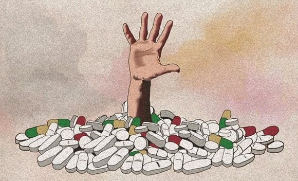 Hand reaching out of a pile of pills