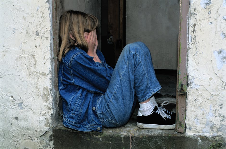 Young girl closing her eyes crying