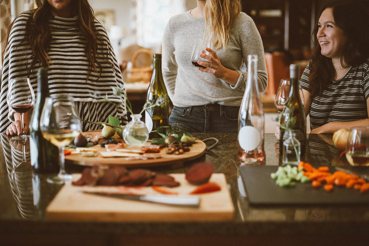 a female group gathering around drinking alcohol.
