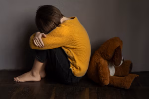 Young girl sitting on the floor crying