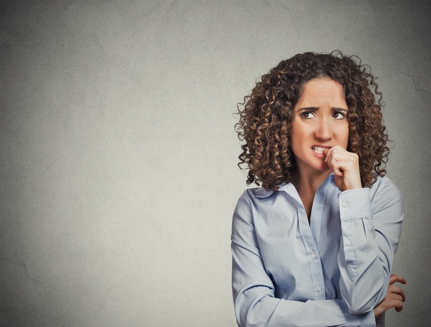 A woman bites her nails as a way of dealing with her stress, although more effective coping skills for anxiety are available
