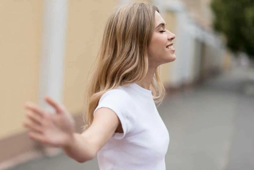 side view woman looking up - break free from people pleaser concept